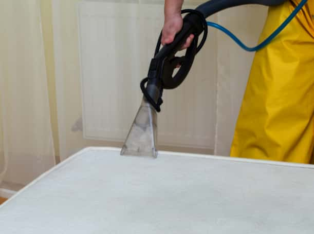 This is a photo of a man steam cleaning a dirty mattress works carried out by Worcester Park Carpet Cleaning