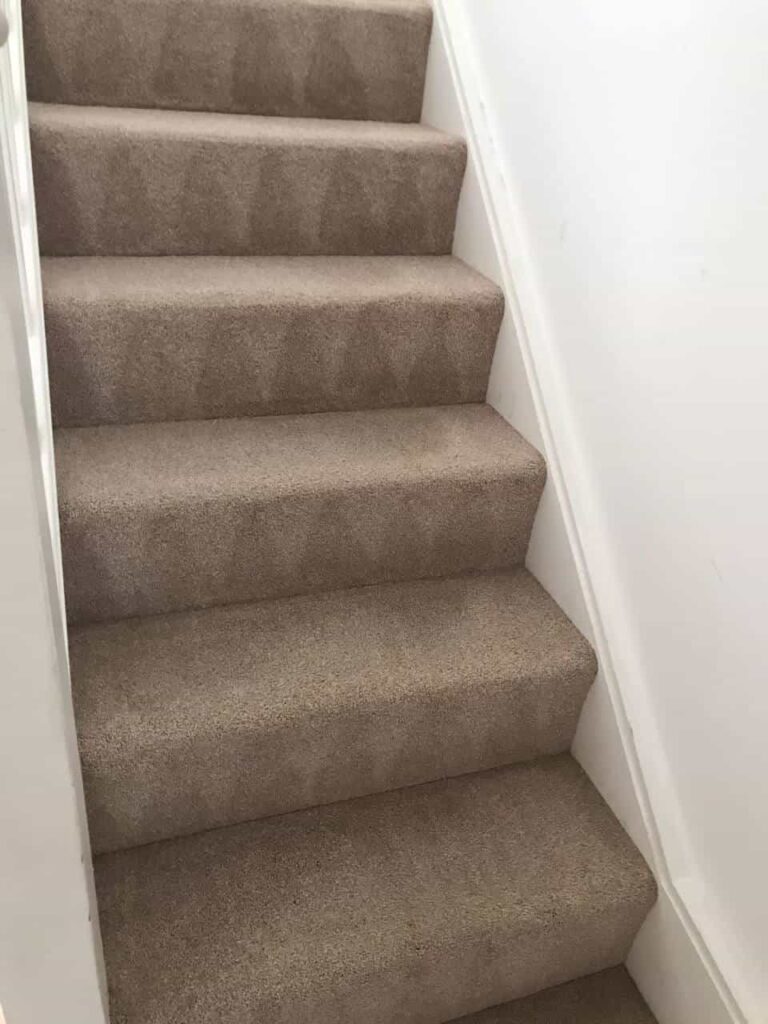 This is an after photo of a staircase with a beige carpet that has been cleaned works carried out by Worcester Park Carpet Cleaning