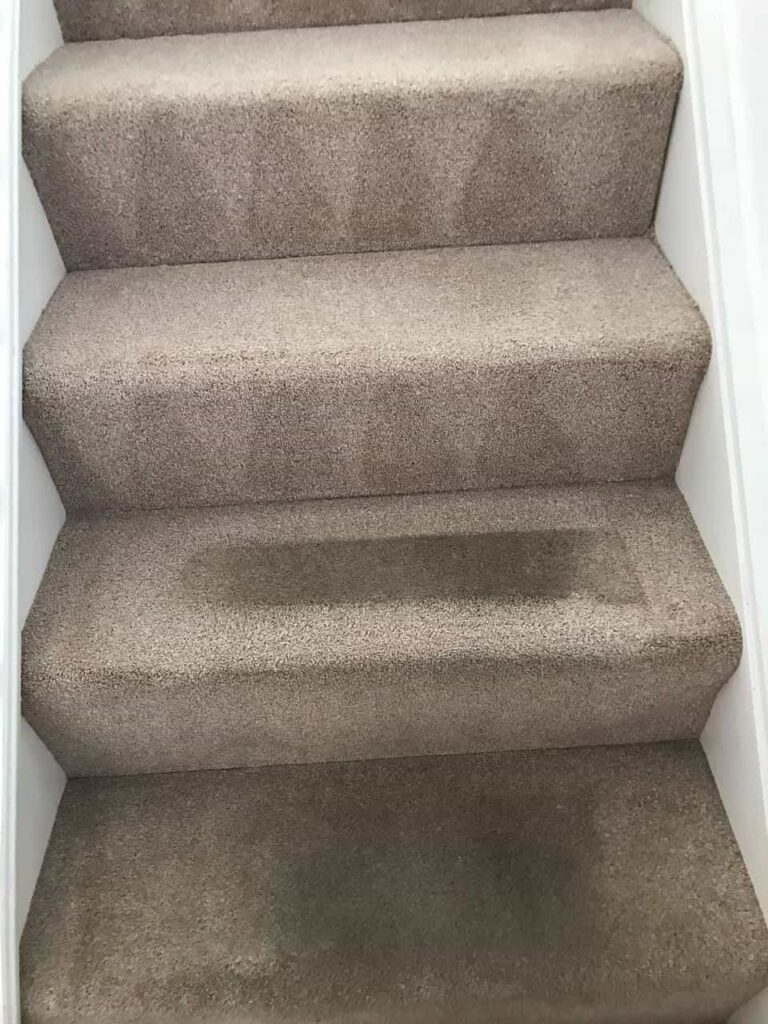 this is a photo of a staircase with beige carpets that is in the process of being cleaned works carried out by Worcester Park Carpet Cleaning